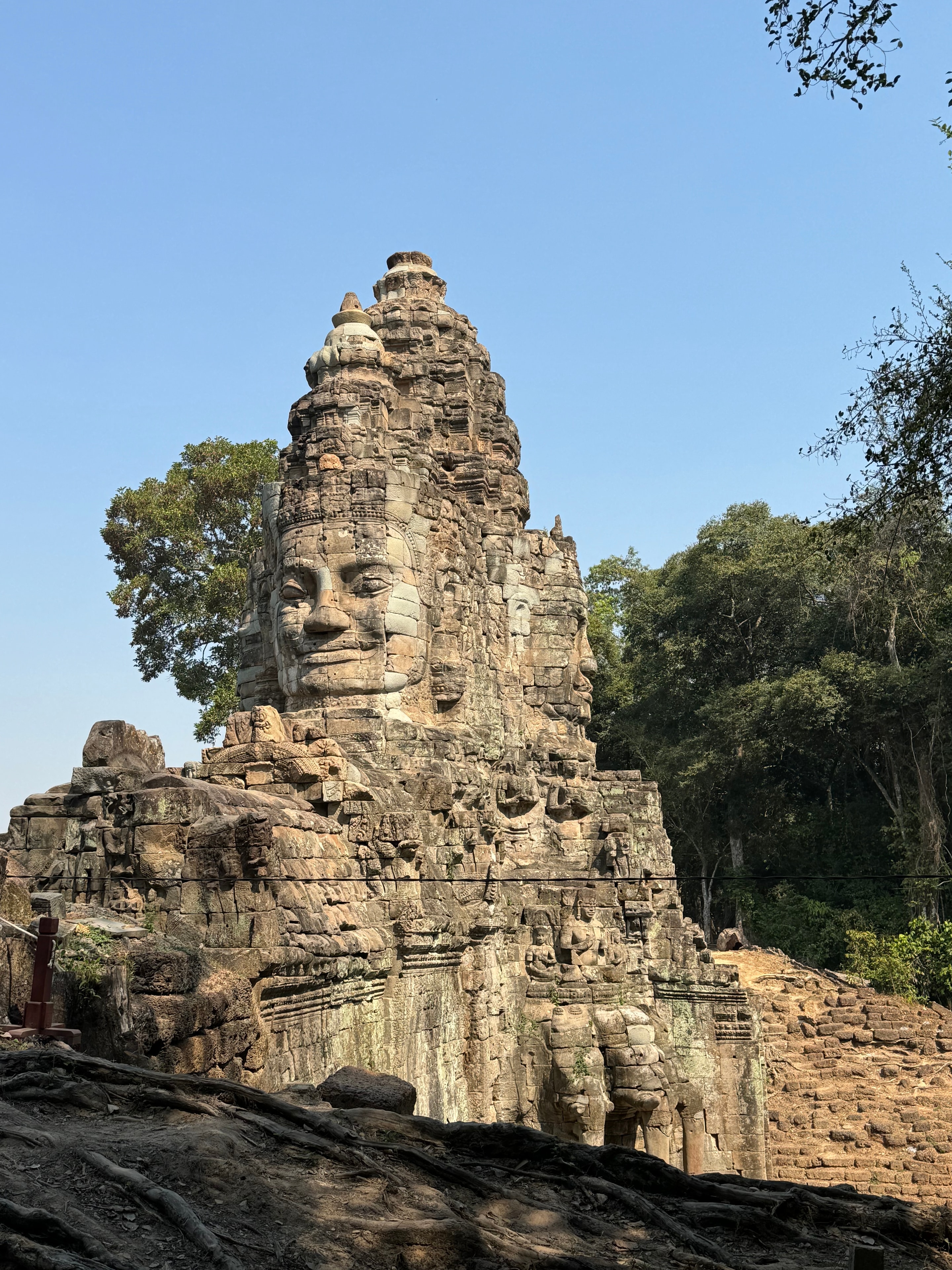 Ho Chi Minh to Angkor Wat — Bayon temple stone face Angkor Thom Cambodia