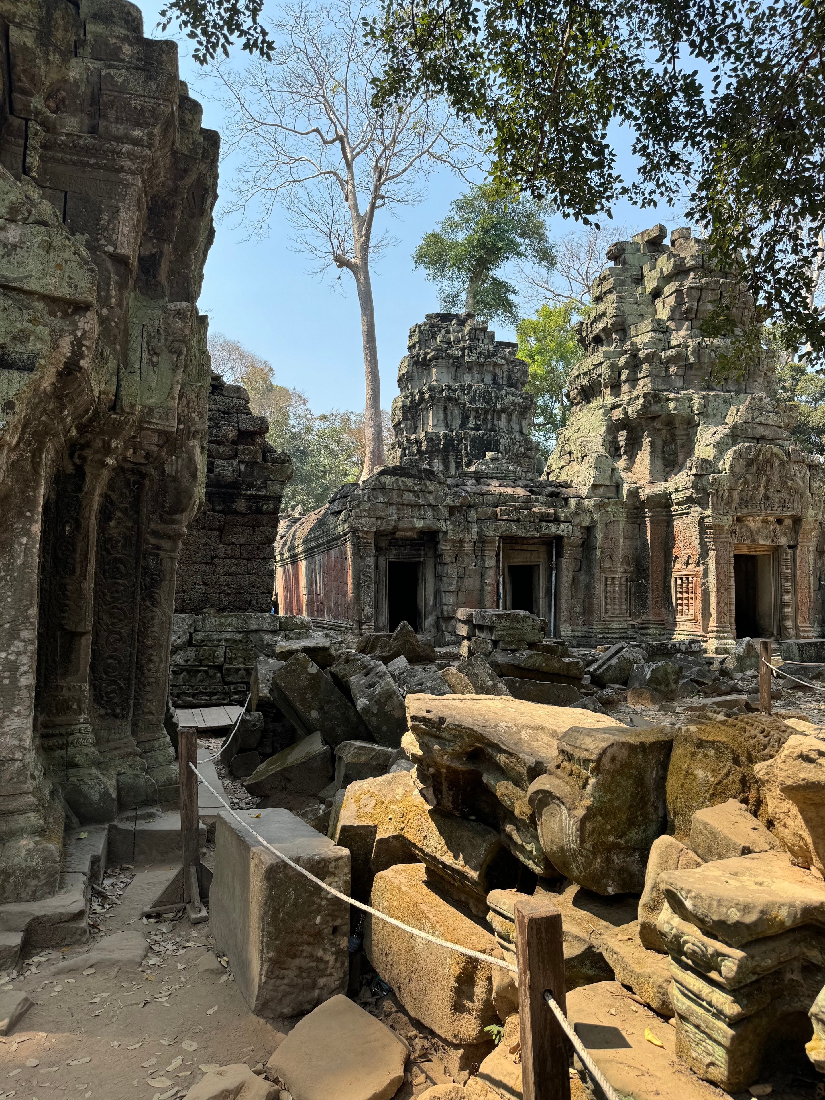 Ho Chi Minh to Angkor Wat — ancient Khmer temple ruins overgrown vegetation